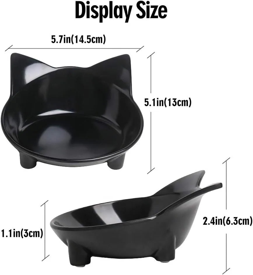Set of four white shallow melamine pet bowls with black non-slip rubber bases on a table.