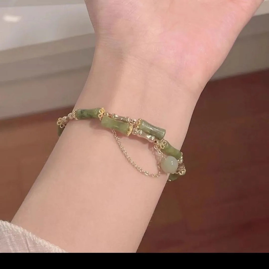 Women's bamboo bead bracelet with coloured glaze beads in plum wine colour showing bamboo joint design