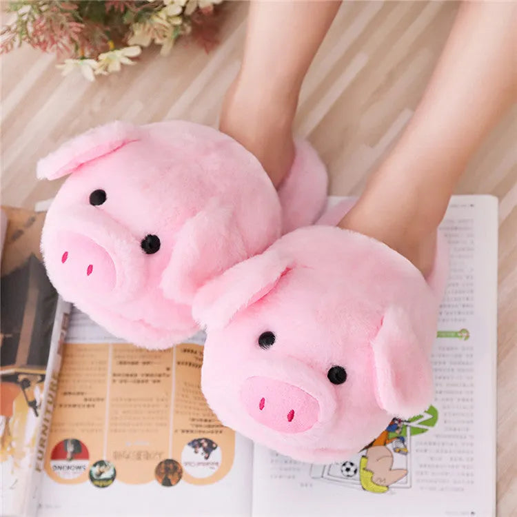 Pink plush pig-themed floor slippers on a white background.