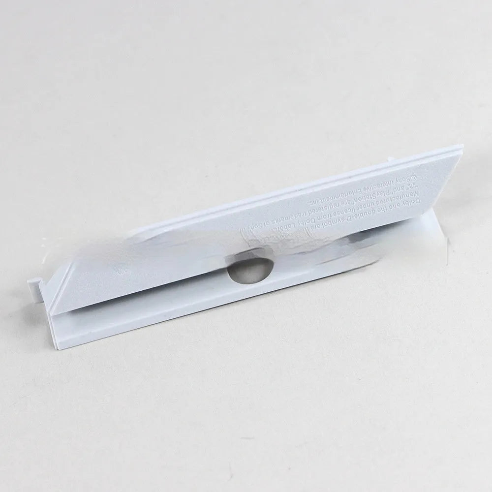Black and white plastic hard drive blanking plates for PC computer cases.
