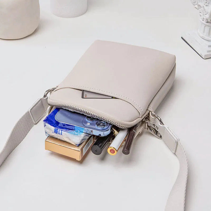 Solid colour PU leather mobile phone crossbody bag showing compact size and shoulder strap.
