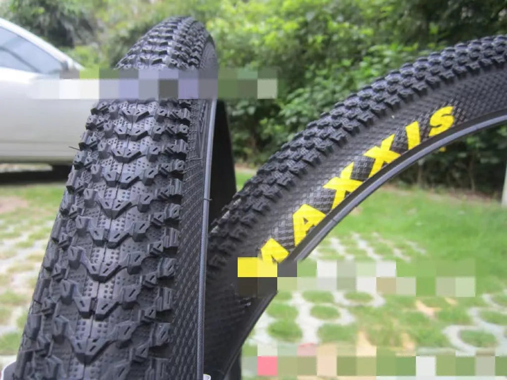 Ultralight black mountain bike tyre with puncture proof tread, shown in 26, 27.5 and 29 inch sizes.