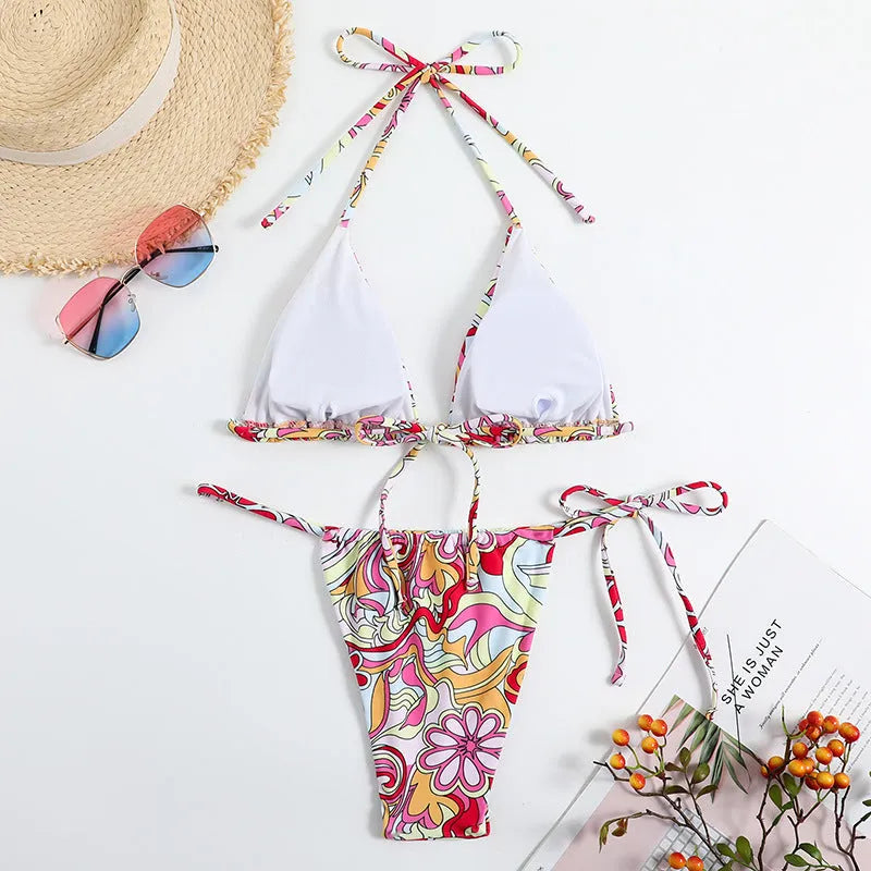 Women's multicolour printed triangle bikini top with hanging neck and matching briefs.