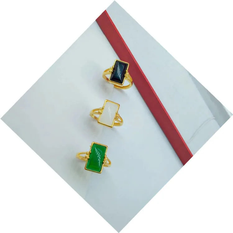 Adjustable brass gold-plated ring with a coloured gemstone in a national style design.