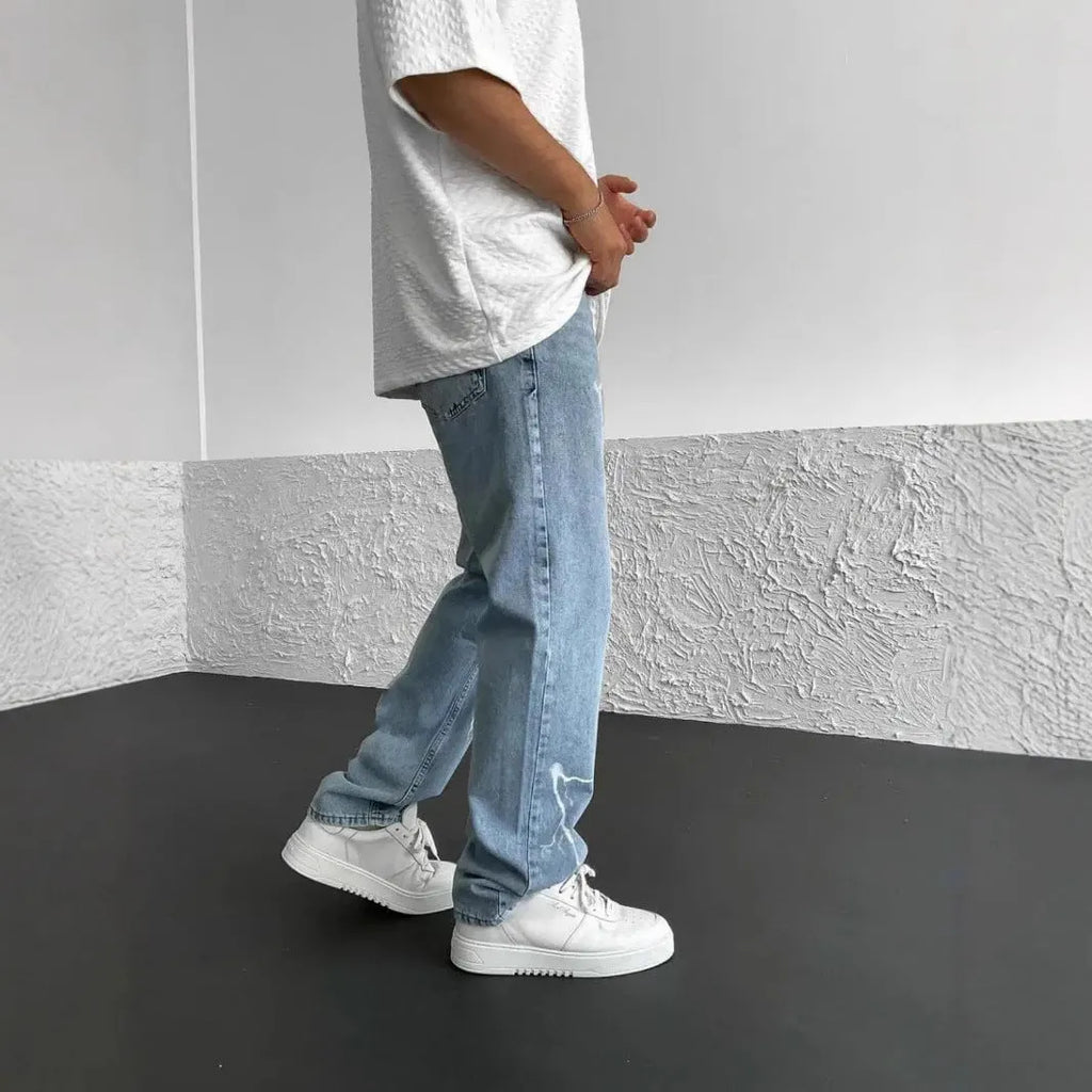 Men's blue straight-leg denim jeans with loose wide-leg cut and zip fly