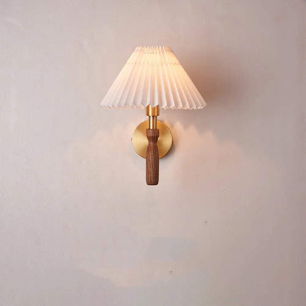 Walnut wood and copper American retro wall lamp with fabric shade on a wall.