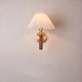 Walnut wood and copper American retro wall lamp with fabric shade on a wall.