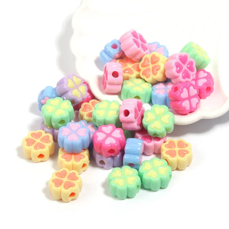 15mm acrylic clover-shaped beads with love pattern in multiple pastel colours including rose red, pink, yellow, green, blue, and purple