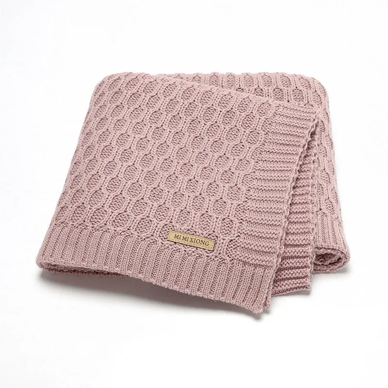Solid colour infant hug blanket with three-dimensional lines in soft acrylic fabric, shown in light green colour