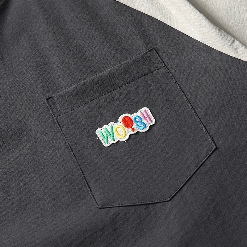 Dark grey loose-fit T-shirt with contrast colour raglan sleeves showing quick-drying polyester construction