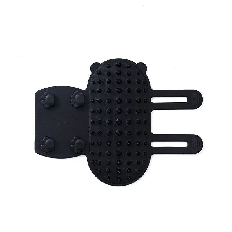 Silicone cat grooming comb with adjustable strap attached to table leg for hair removal and scratching relief