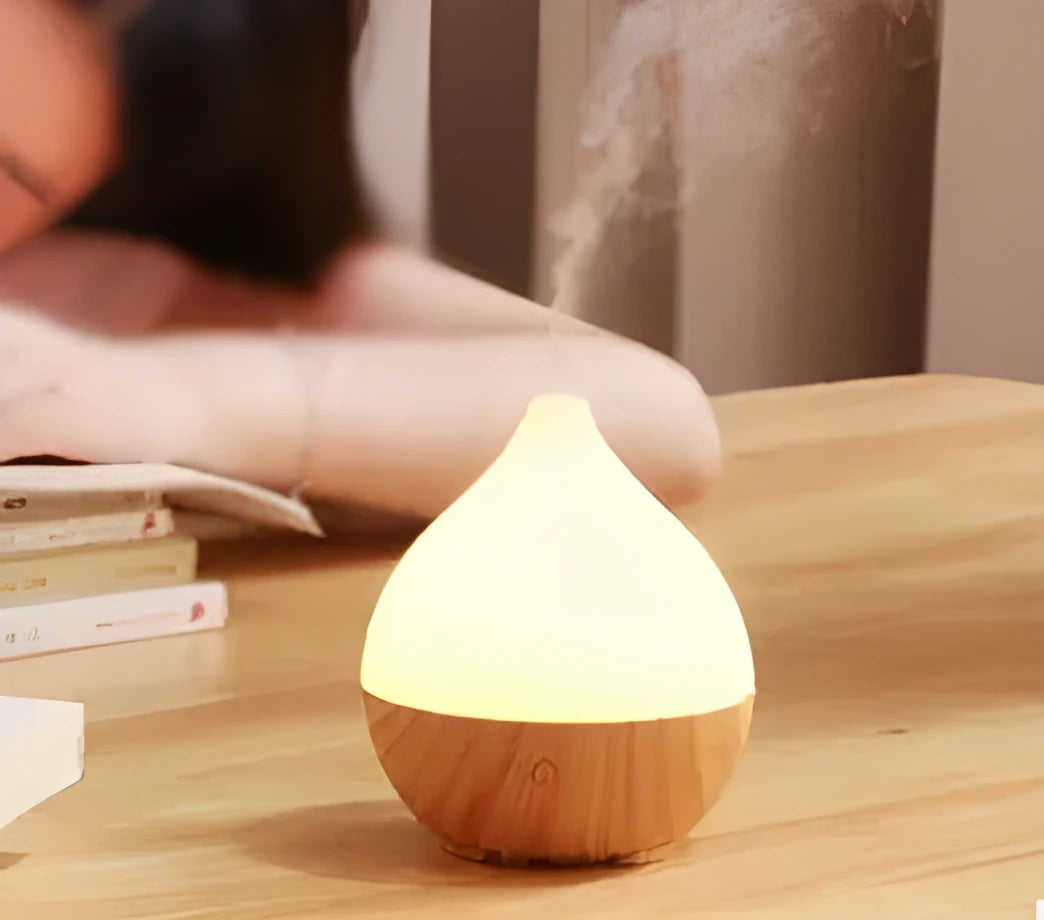 Wood grain finish vase-shaped aroma diffuser with 100ml water tank capacity.