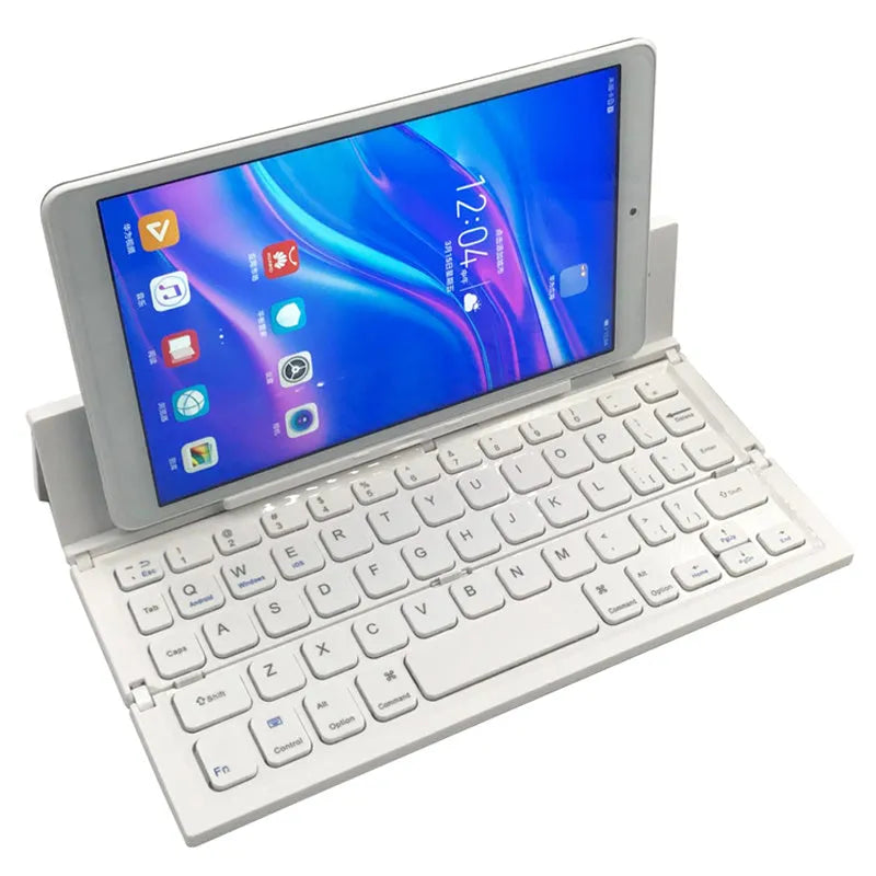 Black mini folding Bluetooth keyboard with bamboo pattern beside 7-inch tablet