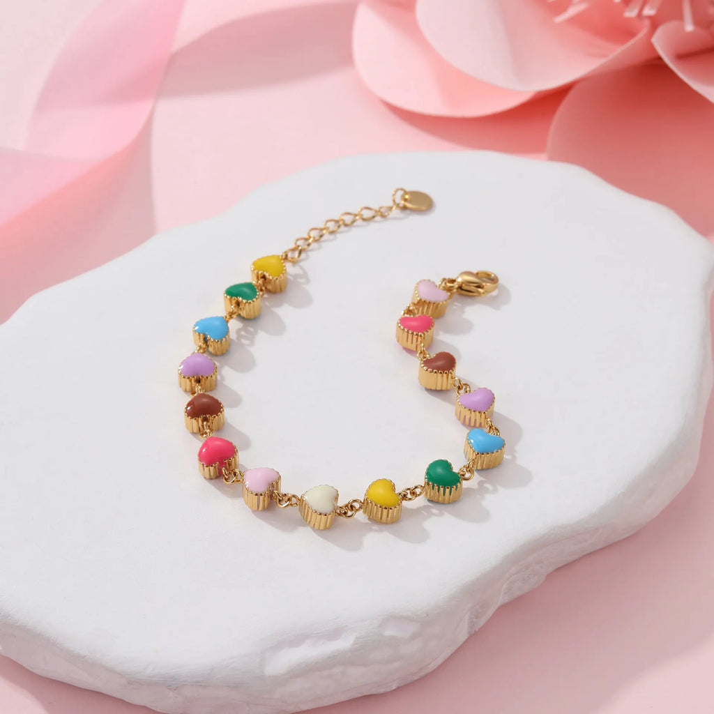 Women's heart-shaped stainless steel bracelet with 18K electroplated finish in gold or steel tone.