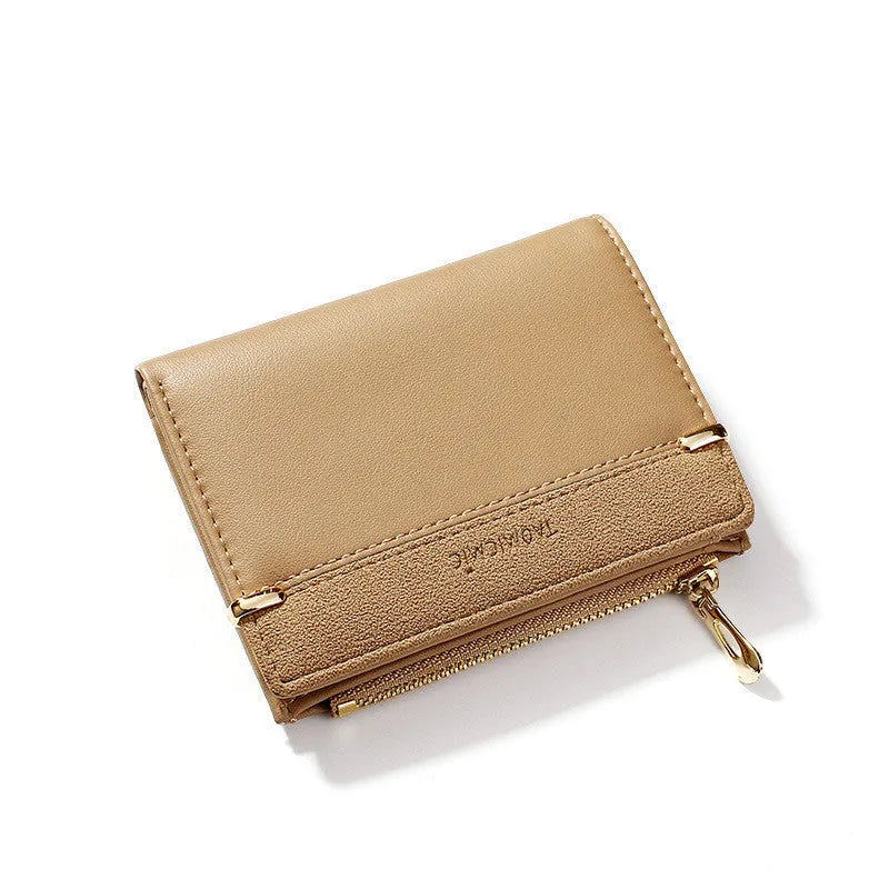 A closed black PU leather ladies wallet with a short zipper, showing its two-fold design.