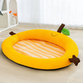 Green fruit-design pet bed with raised backrest, size L shown next to a teddy dog.