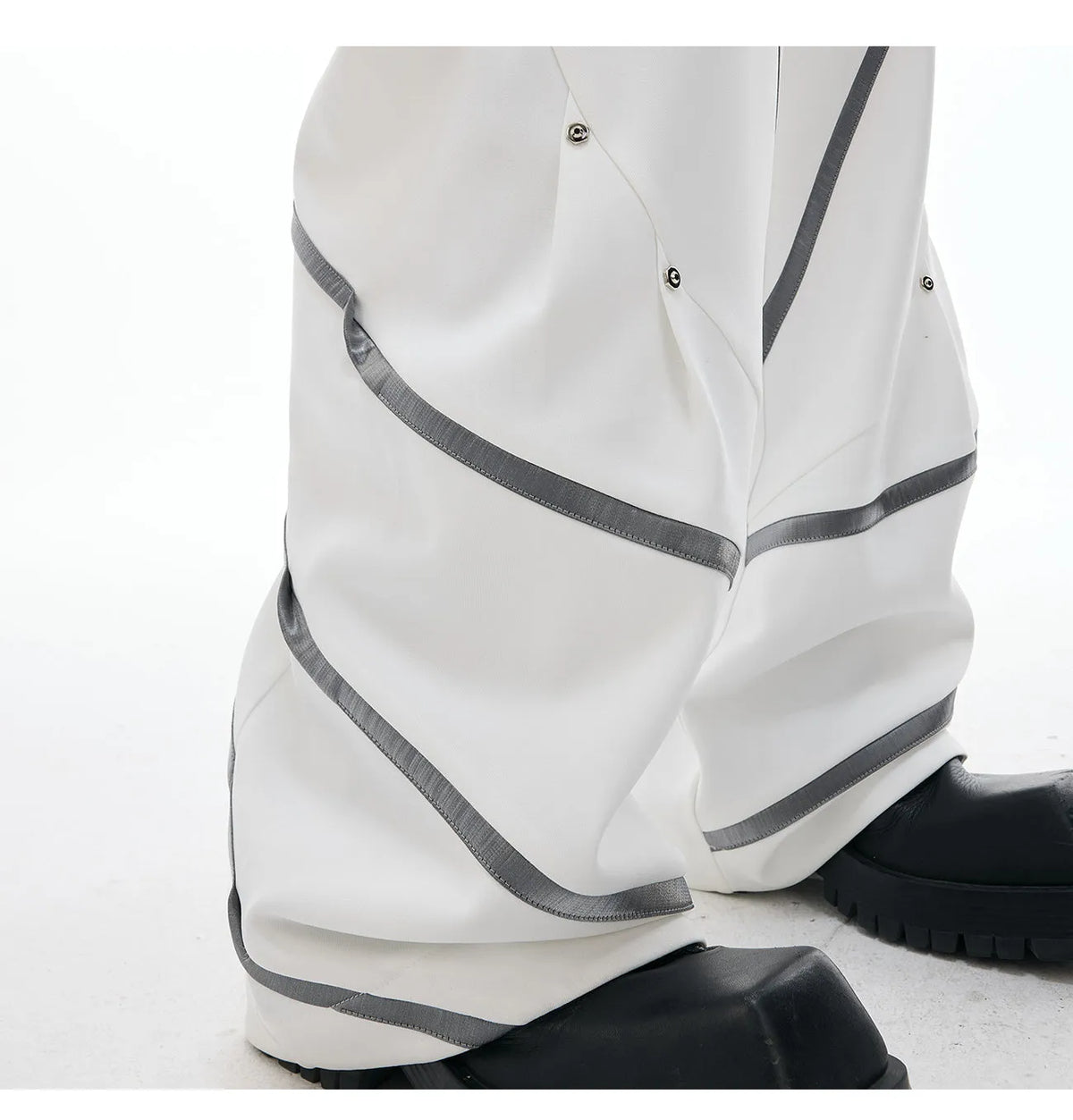 Men's trousers with three-dimensional cutting and metal striped rivet pleated detailing in black or white