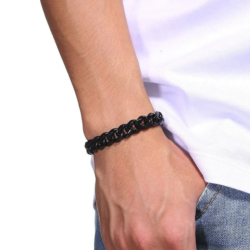 Geometric six-sided Cuban link metal bracelet in gold finish on a grey background.