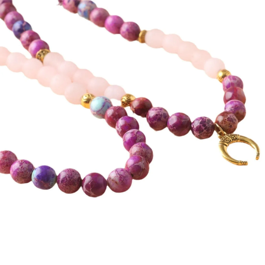 Women's personalised necklace with round Emperor Stone bead pendant showing pink crystal colouration