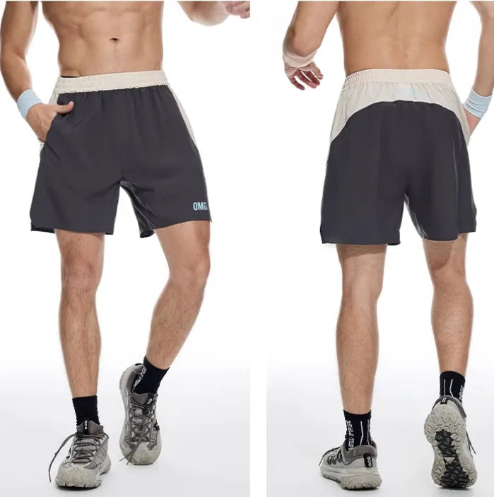 Men's loose grey workout shorts with elastic lace-up waistband on a hanger.
