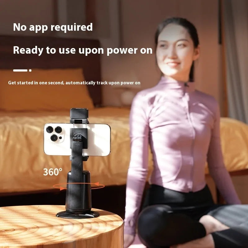 Black ABS desktop phone holder with face tracking, rotating camera head, and built-in LED ribbon lights.