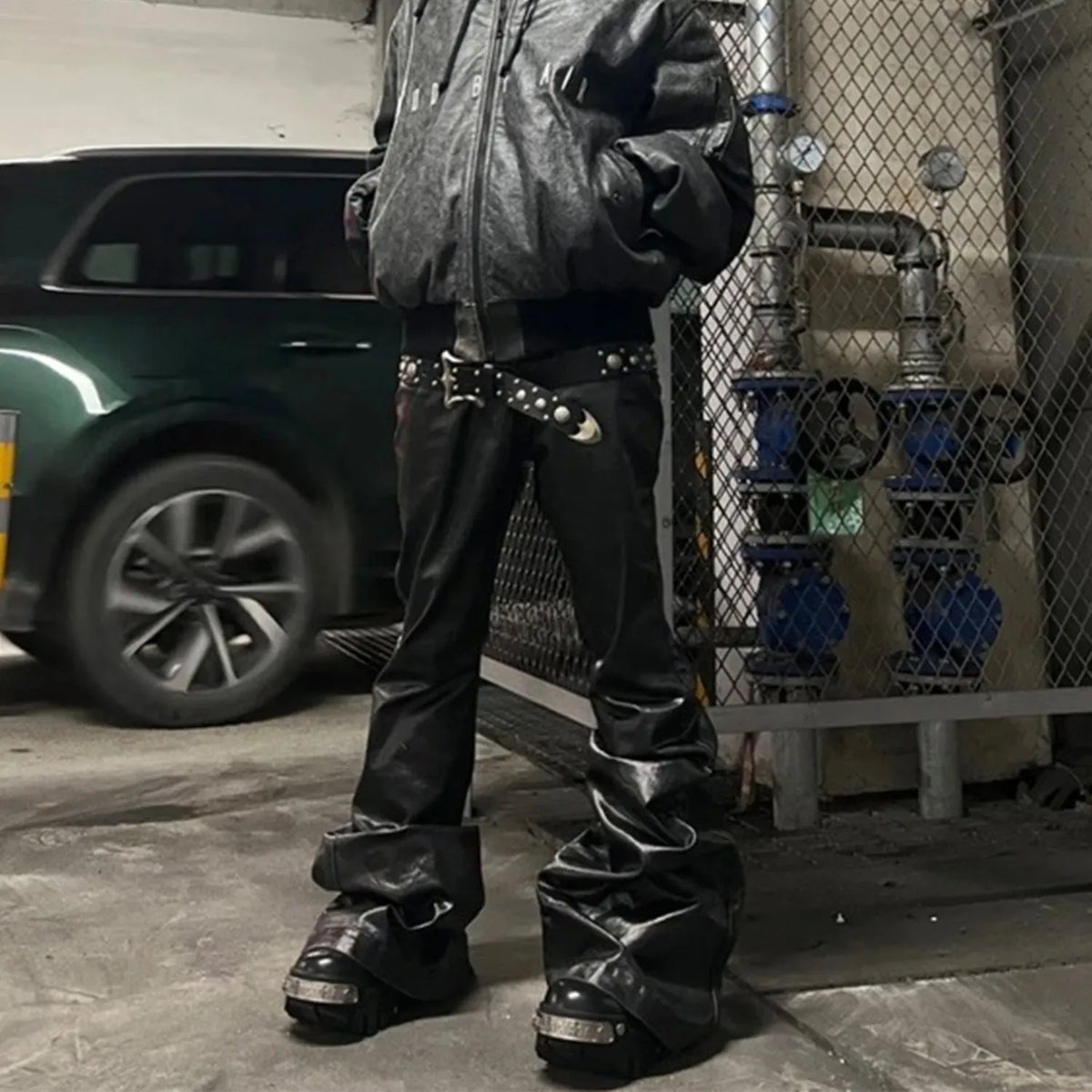 Black shiny patent leather skinny jeans with mid waist and straight leg on a model