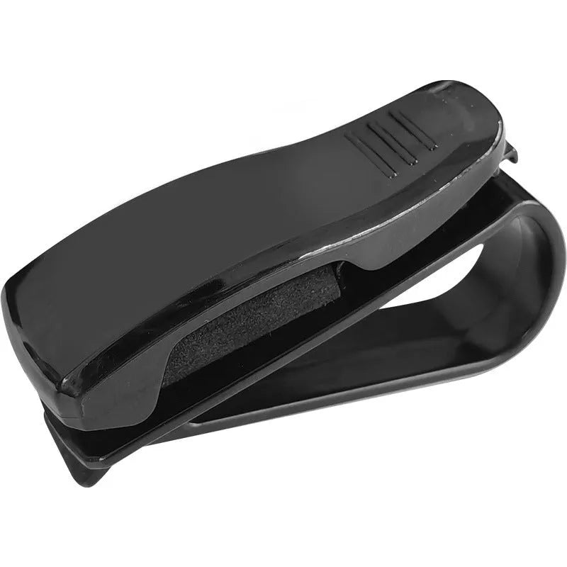 Black plastic car sun visor clip for holding glasses and cards.
