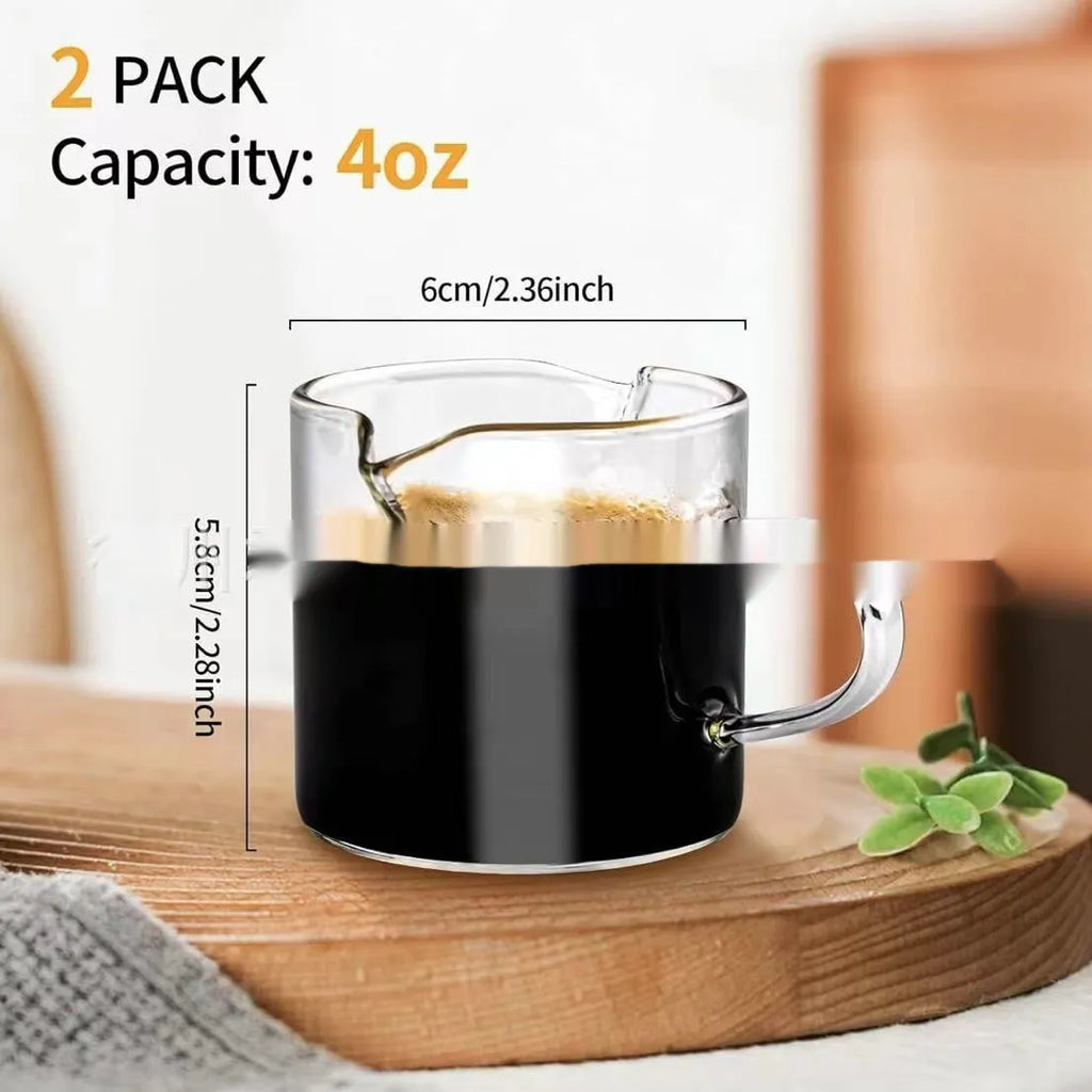 White modern double mouth transparent glass coffee cup set on a table.