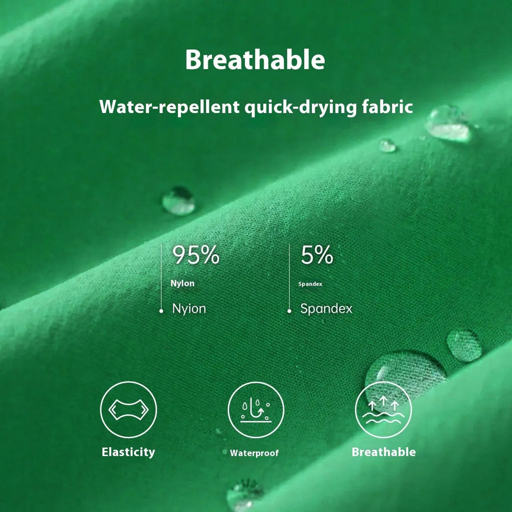 Man wearing solid green quick-drying nylon shorts with a straight leg opening on a beach.
