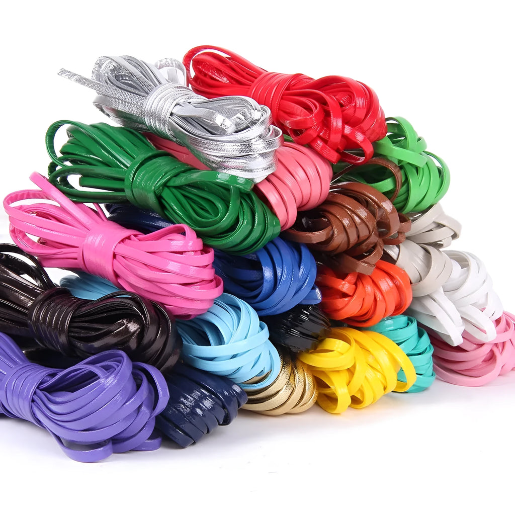 Coiled PU leather woven cord in multiple colours showing beige, black, blue, and red options on a wooden surface.