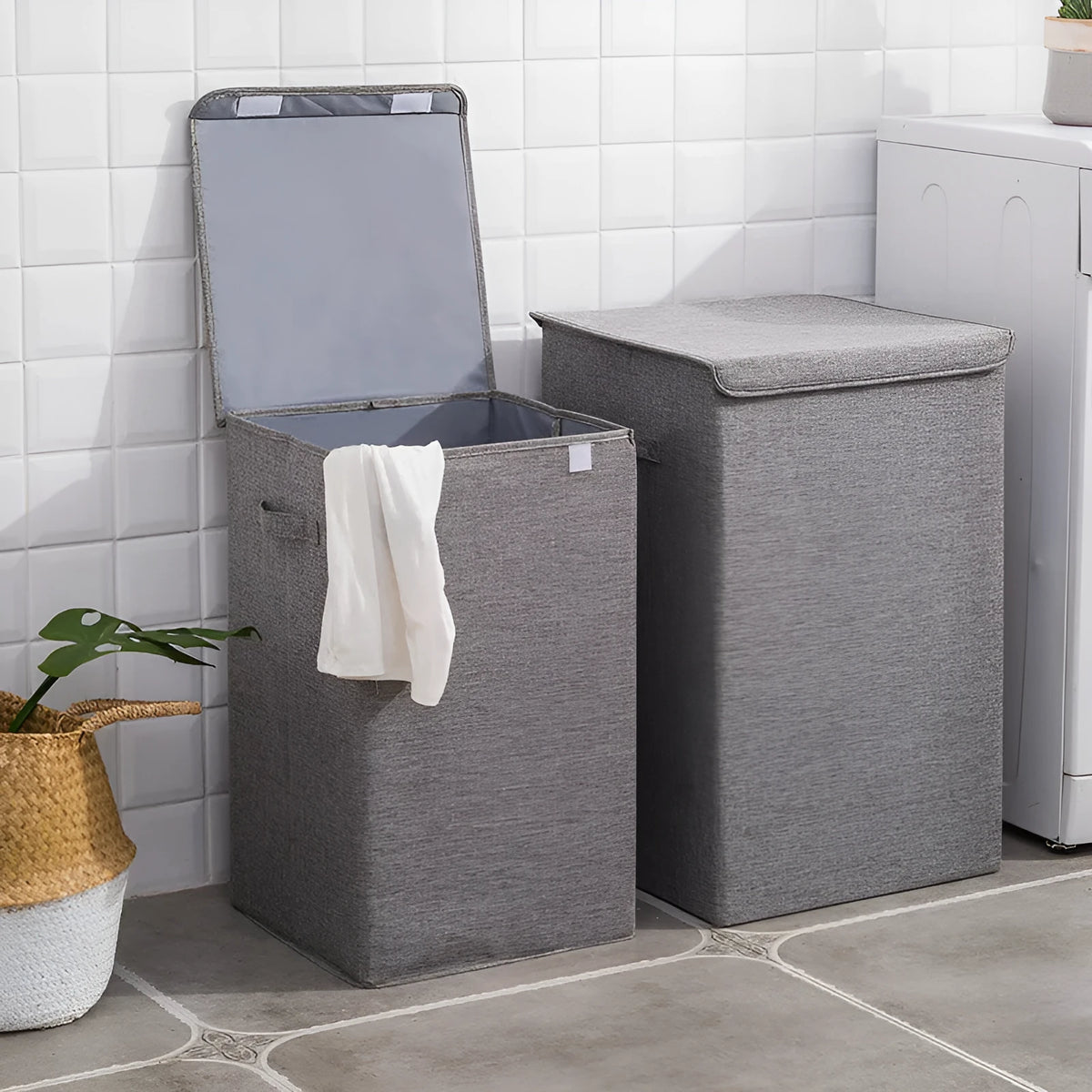 Foldable cotton linen storage basket in grey, shown in a modern room holding clothes and books.