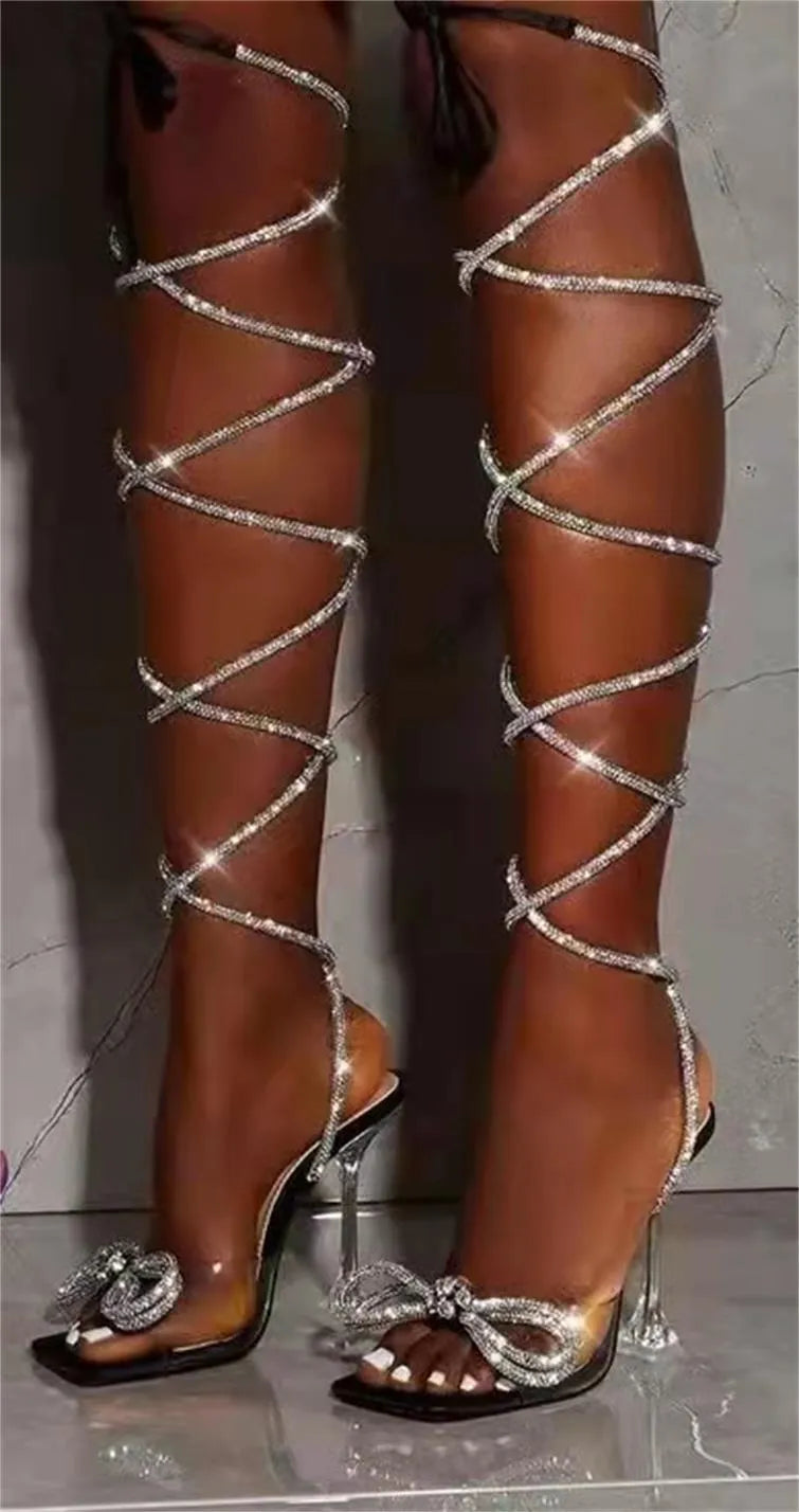 Plus size women's black strappy sandals with rhinestone Roman straps and a square toe.