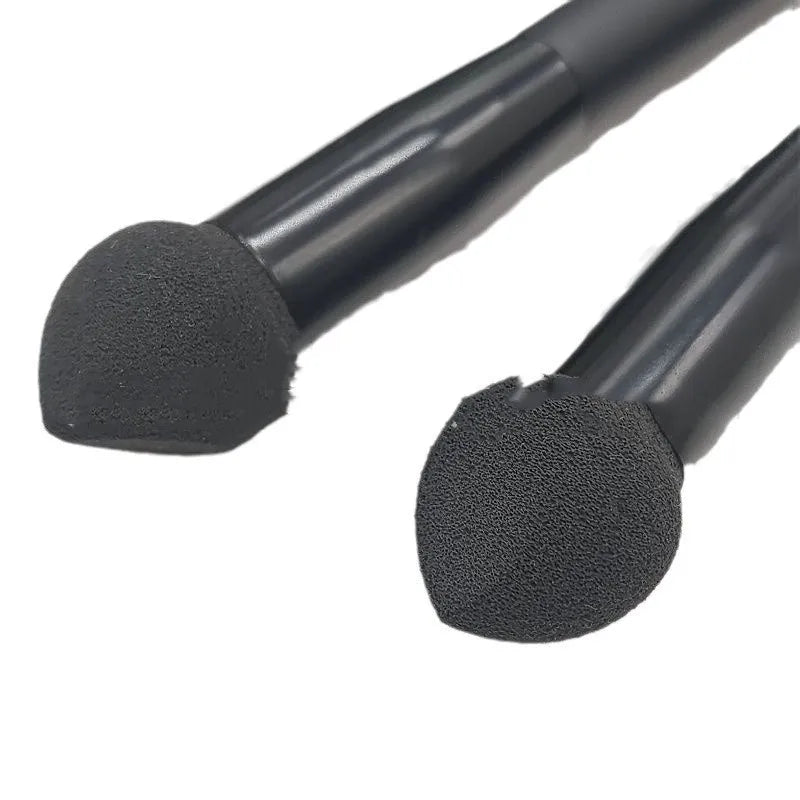Black concealer brush with sponge tip and wooden handle for dark circle application