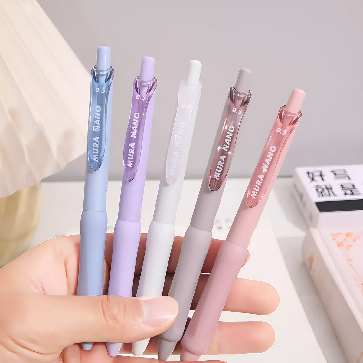 Macaron colour press gel pen with 0.5mm tip shown in smoked brown, smoked powder and smoked white refill options