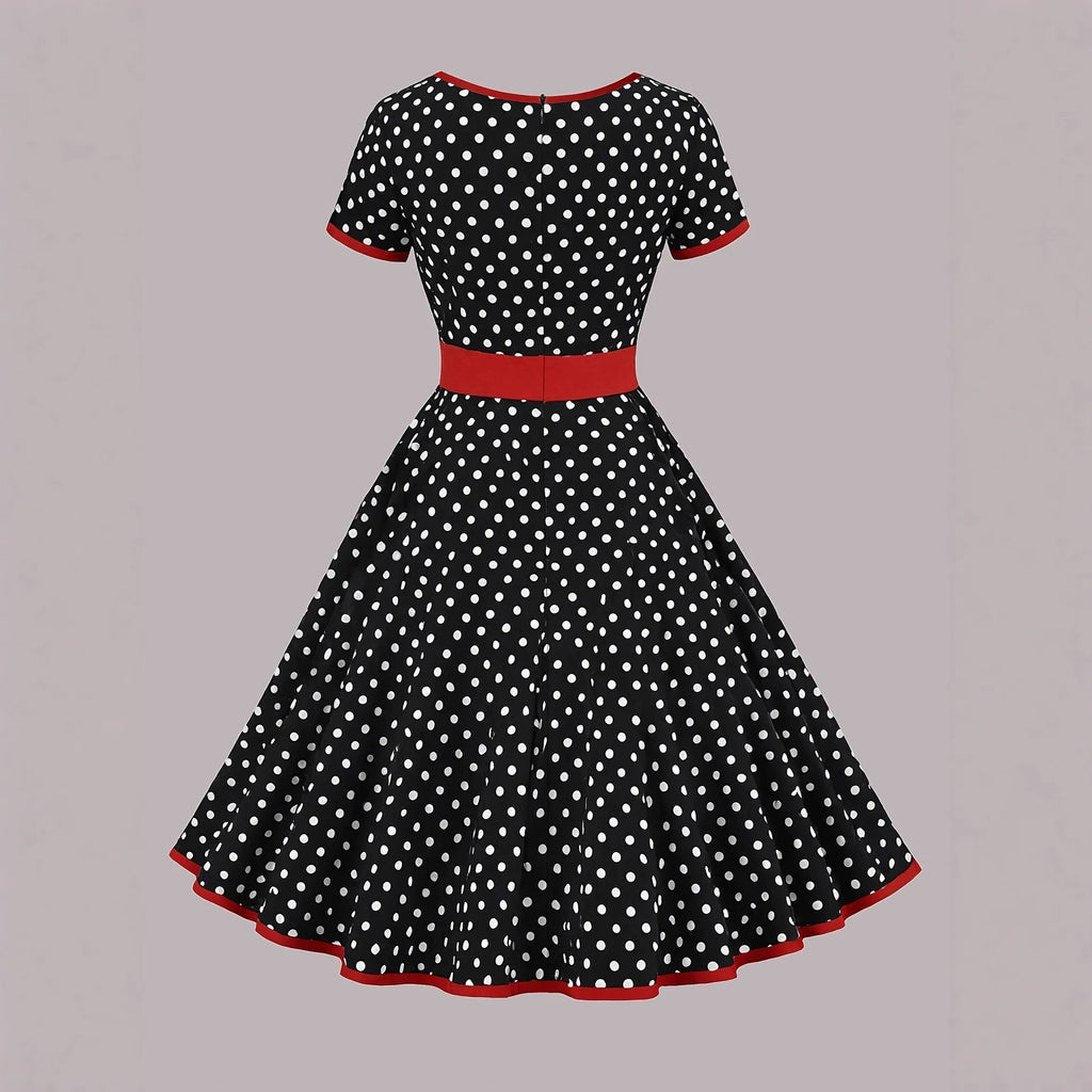 Multicolour polka dot women's dress with square collar, short sleeves, and pleated mid-length skirt.