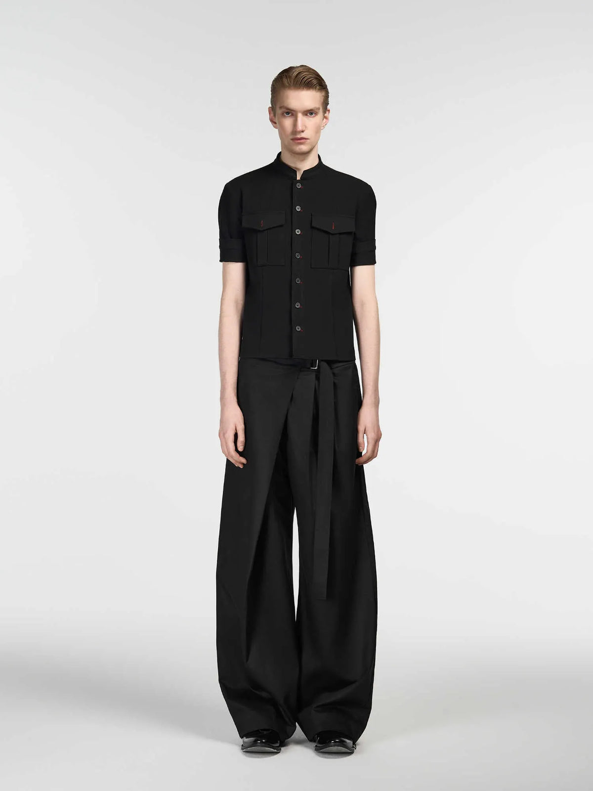 Black straight-leg trousers with an adjustable waistband and a single pleat detail.