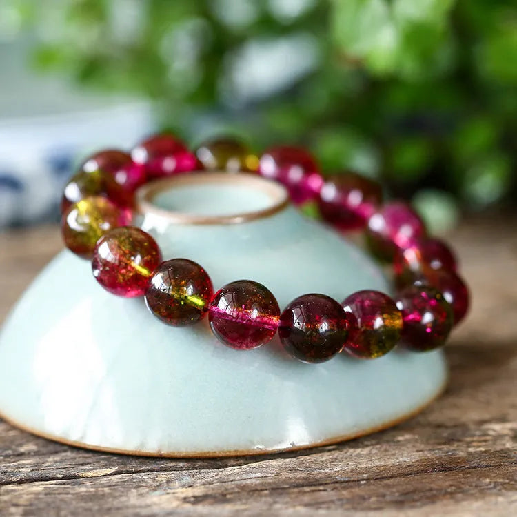 Women's handmade watermelon crystal bracelet on wrist, showing pastoral style and available bead sizes.