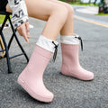 Women's solid colour PVC rain boots with a non-slip sole.
