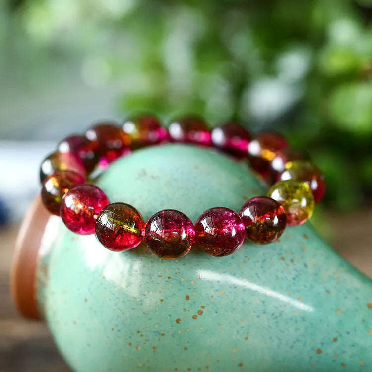 Women's handmade watermelon crystal bracelet on wrist, showing pastoral style and available bead sizes.
