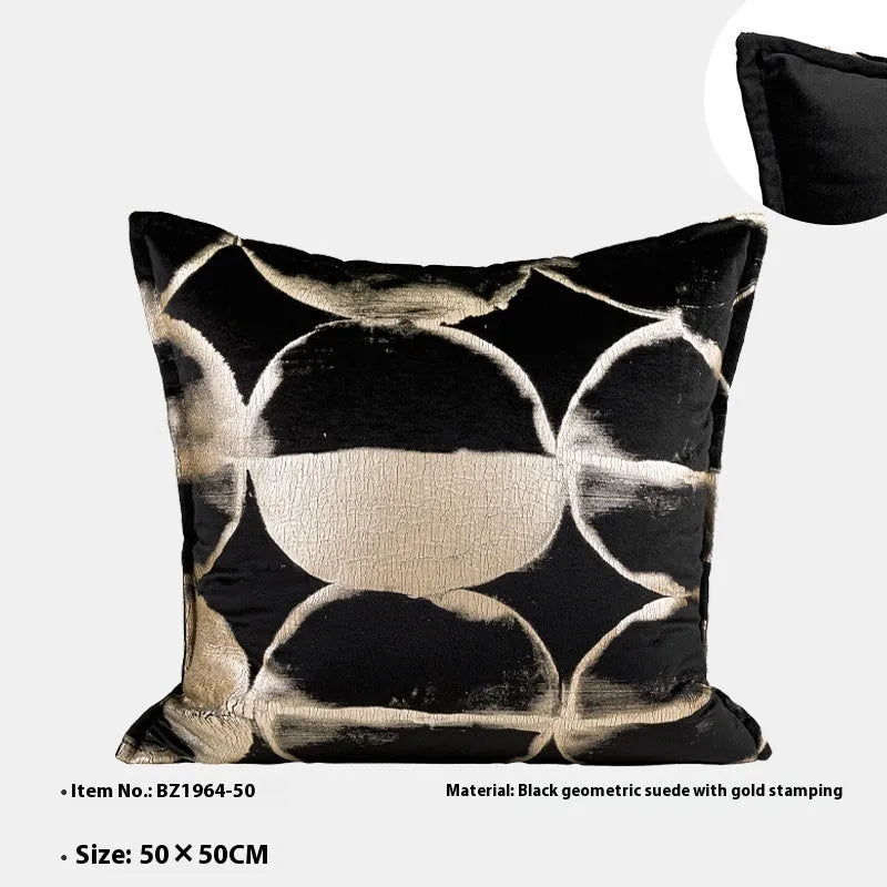 Black and gold abstract pattern square cushion with removable feather velvet cover on a sofa.