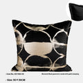 Black and gold abstract pattern square cushion with removable feather velvet cover on a sofa.