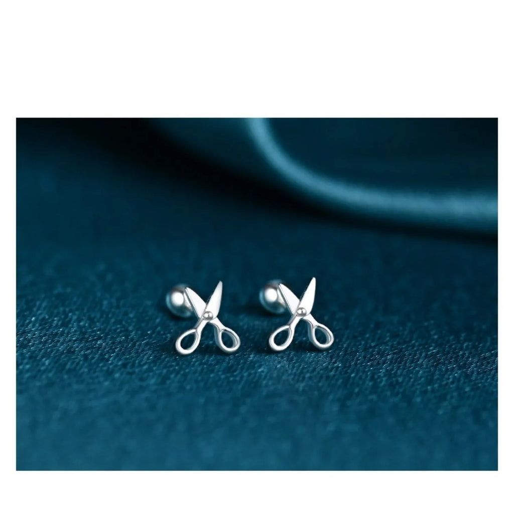 A pair of pure silver earrings with a miniature scissors design and screw-on backs.