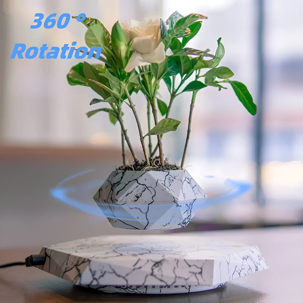 Small marble-colour plastic plant pot floating above a magnetic base unit.