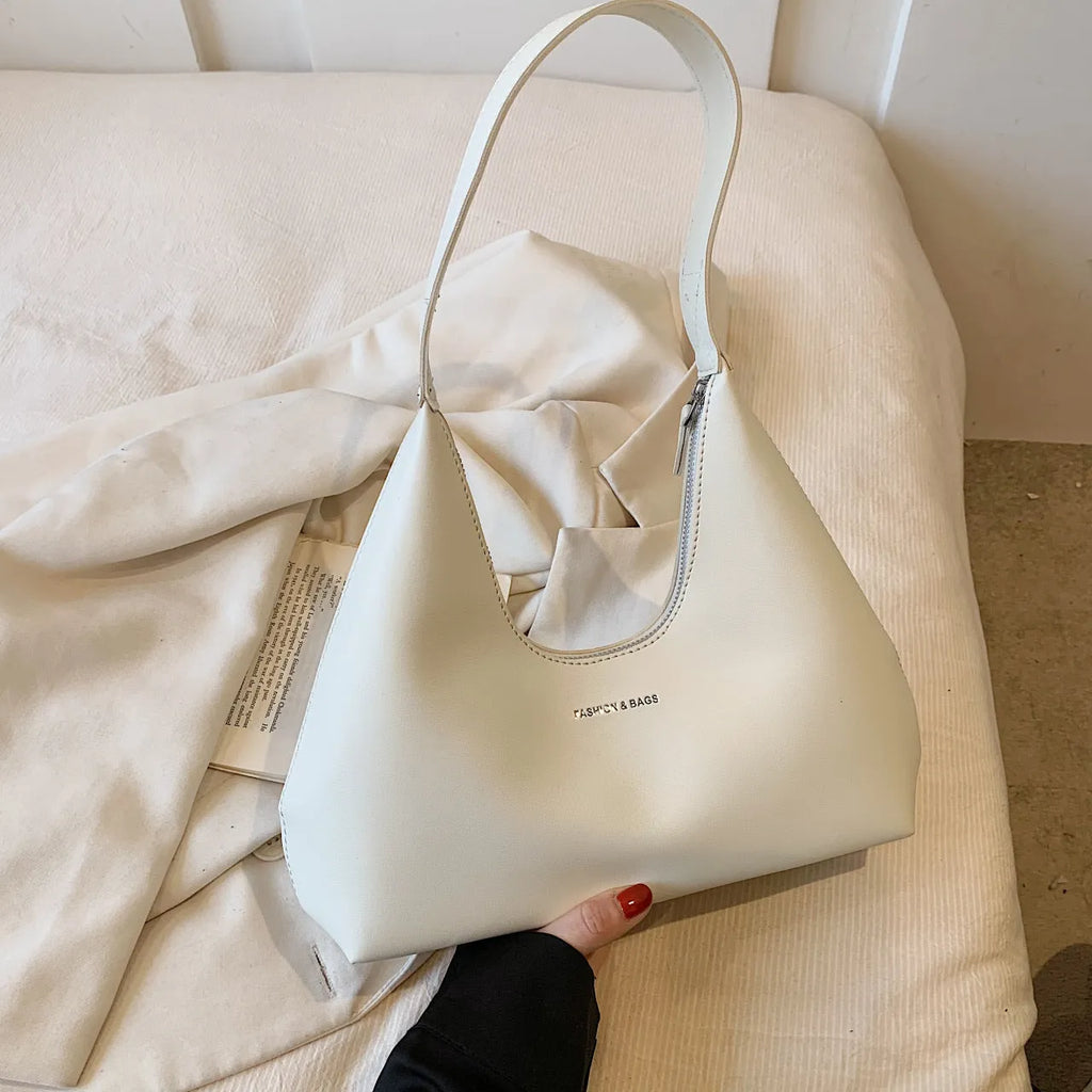 Brown retro-style PU leather pillow-shaped shoulder handbag with a single strap.
