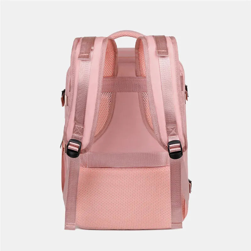 Large purple travel backpack with multiple compartments, shown next to a laptop.