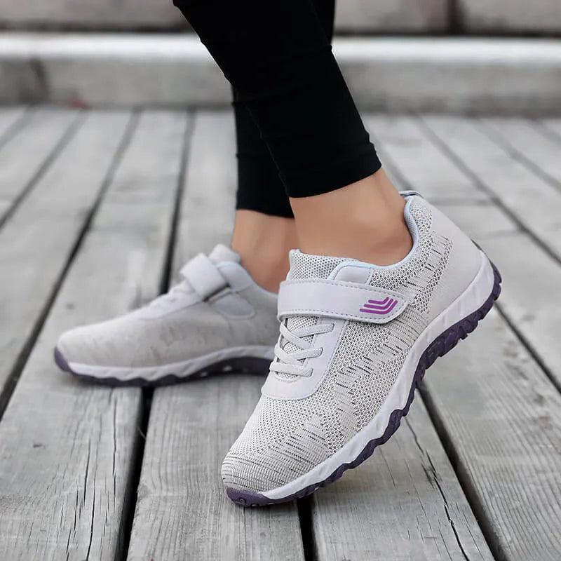 Grey purple women's low-top shoes with a velcro strap and wedge sole on a white background.