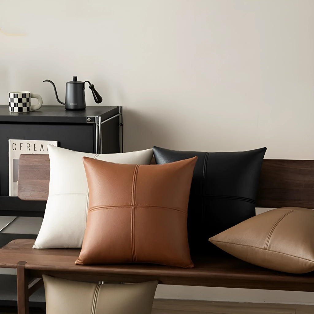 Solid colour soft cowhide leather pillow cover in brown on a neutral background