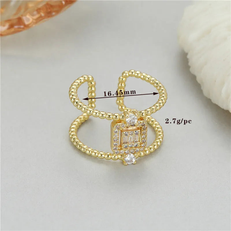 Gold-coloured adjustable open ring with an asymmetric U-shape design.