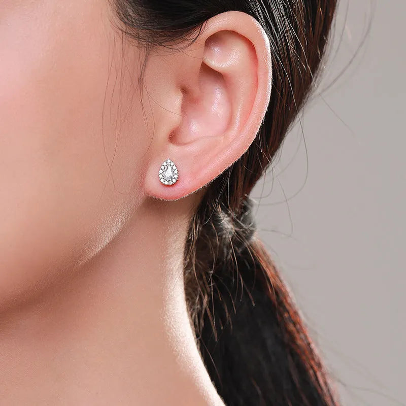 A pair of women's sterling silver water drop ear studs with a diamond-cut shiny finish.