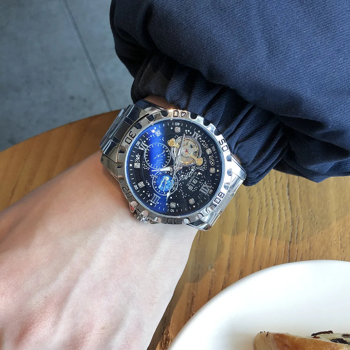 Men's silver automatic mechanical watch with black starry dial and luminous hands on leather strap